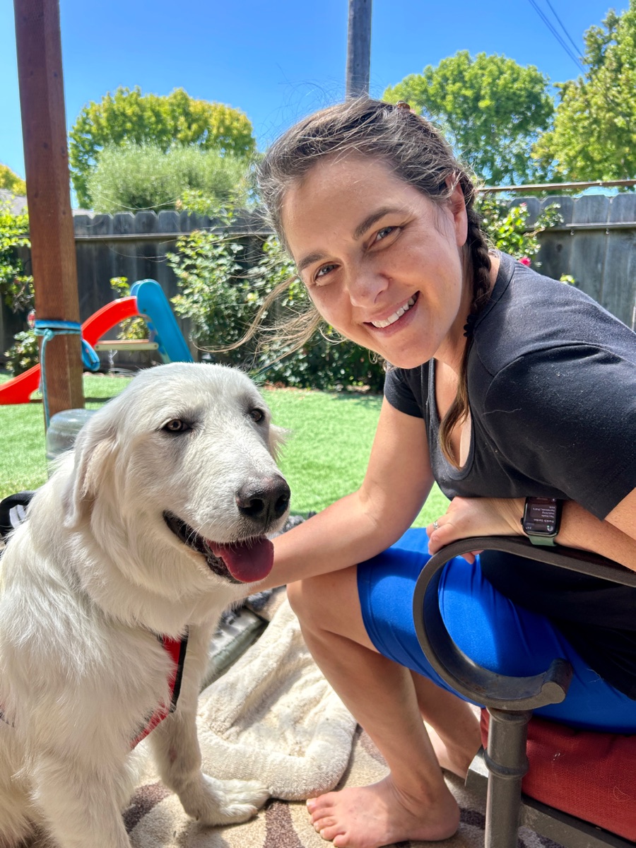 Georgia with Samuel the Great Pyrenees in the backyard